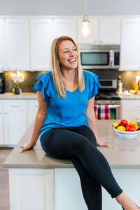 Branding portrait of a Bend Oregon professional sitting on a bright modern kitchen