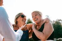 candid wedding photographer at pengenna manor captures guests laughing in the sun