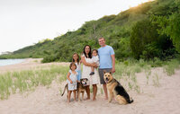 Family photography session on the beach in West Bend Wisconsin with playful kids and dogs