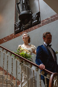 Bride exits wedding down Pitzhanger gallery staircase