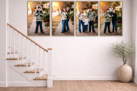 Gallery wall of four framed vertical family portraits from a downtown New Bern photo session displayed along staircase wall in bright neutral home