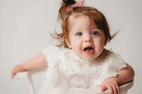 Charleston Cake Smash Photographer -- Baby celebrates her first birthday with a Cake Smash Photoshoot at Holy City Babies Portrait Studio in Charleston, SC.
