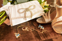 Detail shot from a wedding, focusing on jewelry and clutch by Graceful Ray Photography.