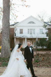bride and groom walk hand in hand at Melrose Knitting Mill wedding venue