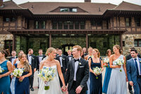 Bride & Groom with Guests in Front of Building