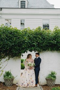 bride and groom posing in front of venue