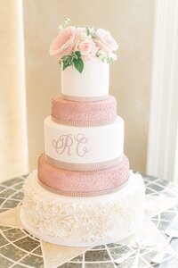 custom wedding cake with pink flowers on top