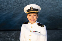 Midshipman smiles for her senior photos by Kelly Eskelsen at the USNA in Annapolis Maryland.