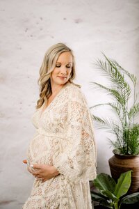 studio maternity session with a mom to be in a cream boho dress 