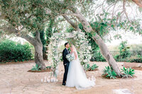 bride and groom standing in a garden