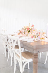 bright light and airy wedding photo of tablescape florals place settings