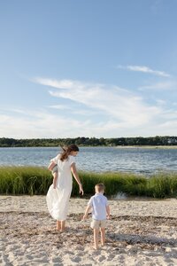 A coastal New England family session with toes in the sand and salty snuggles by the water's edge. North Shore Family Photographer. Deborah Zoe Photography.