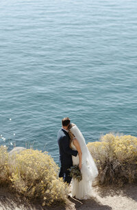 lake tahoe elopement couple hugging and looking at the blue water