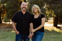 Couple standing close together outdoors with soft golden backlight, timeless natural portrait by Kaitlyn Dawn Photography, professional couples and family photographer.