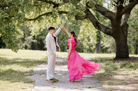 candid prom picture of couple dancing under oak tree