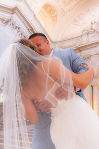 wedding couple dip kiss at san francisco city hall wedding