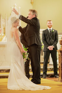 Bride veil lifting in Los Angeles during a romantic portrait with true to life color and soft cinematic light.