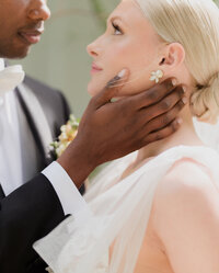 multicultural couple. black groom and white bride artfully captured on their wedding day.