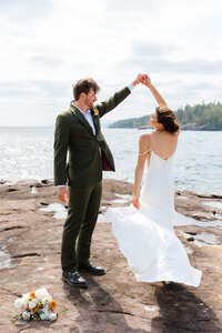 Bride twirling with her groom at a Grand Marais beach