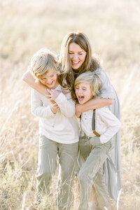 A mother playing with her 2 sons at a local Frisco TX park.