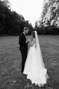 High-end elegant couple posing in a wild mountain meadow in Šumava National Park, blending luxury style with raw natural beauty.