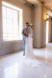 san francisco city hall wedding first look embrace