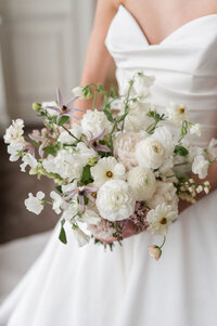 Bride holding floral bouquet by one of the best cincinnati wedding photographers