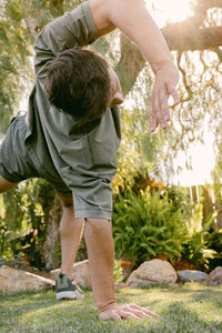 Man stretching in a sunlit backyard, shot for Mochi Health's longevity vertical