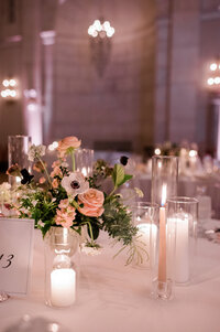 Candles lit in glass vases around the tables