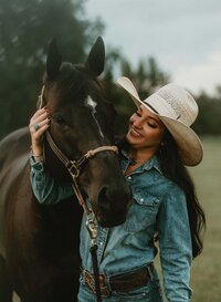 Senior portrait at Triple T Farms in Fruitdale, Alabama — smiling at her horse.
