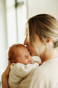 Candid moments captured during a newborn photoshoot in Christchurch