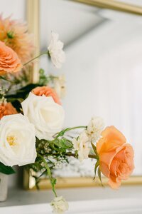 Peach and ivory rose floral detail reflected in gold mirror by Flowergirl Cville, Charlottesville VA wedding florist | Photo by Lyn Waldrop Photography