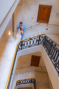 bride and groom in stairwell at san francisco city hall wedding