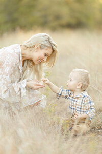 A photo of a DFW mother holding a piece of grass her baby boy gave her.