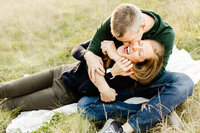 Playful husband and wife kissing at a family session at Cantigny Park in Wheaton, IL