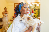 Venice Beach Los Angeles wedding photography of the bride getting ready with her small dog in wedding attire, captured in a candid documentary moment with true to life color and soft natural light.