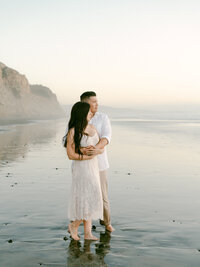 A serene engagement moment at The Lodge at Torrey Pines captured by Michael Asmussen Photography. Amid whispering pines and timeless California architecture, the couple celebrates with rosé and effortless laughter—an image of warmth, elegance, and genuine connection.