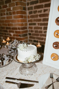 one tier all white wedding cake with delicate florals