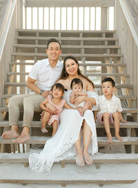 Niceville family photographer session, family of six sitting together on outdoor steps