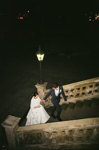 Romantic night portrait of a bride and groom at Letenský zámeček in Prague, captured on film with a timeless atmosphere.