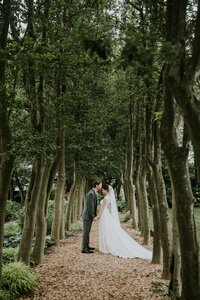 Wedding portraits under trees at Yew Dell Botanical Gardens