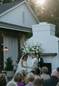 bride and groom standing at wedding ceremony together