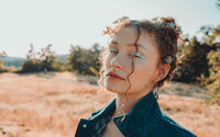 Colorful editorial portrait featuring floral styling and a creative fashion look.