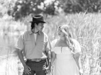 Black and white photo of a couple posing for a romantic summer engagement portrait in Orange County.