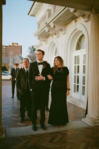 A groom standing with his mom waiting for the ceremony to begin in Harrisburg PA shot on film.