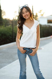 High school senior girl smiling during a golden hour outdoor portrait session, senior photography by Kaitlyn Dawn Photography.