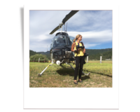 photographer posing in front of helicopter during wedding at Olympic Stables at palisades tahoe.