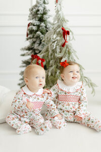 Professional branding photo of 2 babies modeling Dondolo christmas clothing