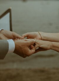 A closeup of a bride and groom's hands with an engagement ring on the bride's finger | Venue Business Boot Camp