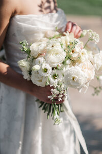 Close-up of bride holding a white floral bouquet captured in Detroit wedding photography